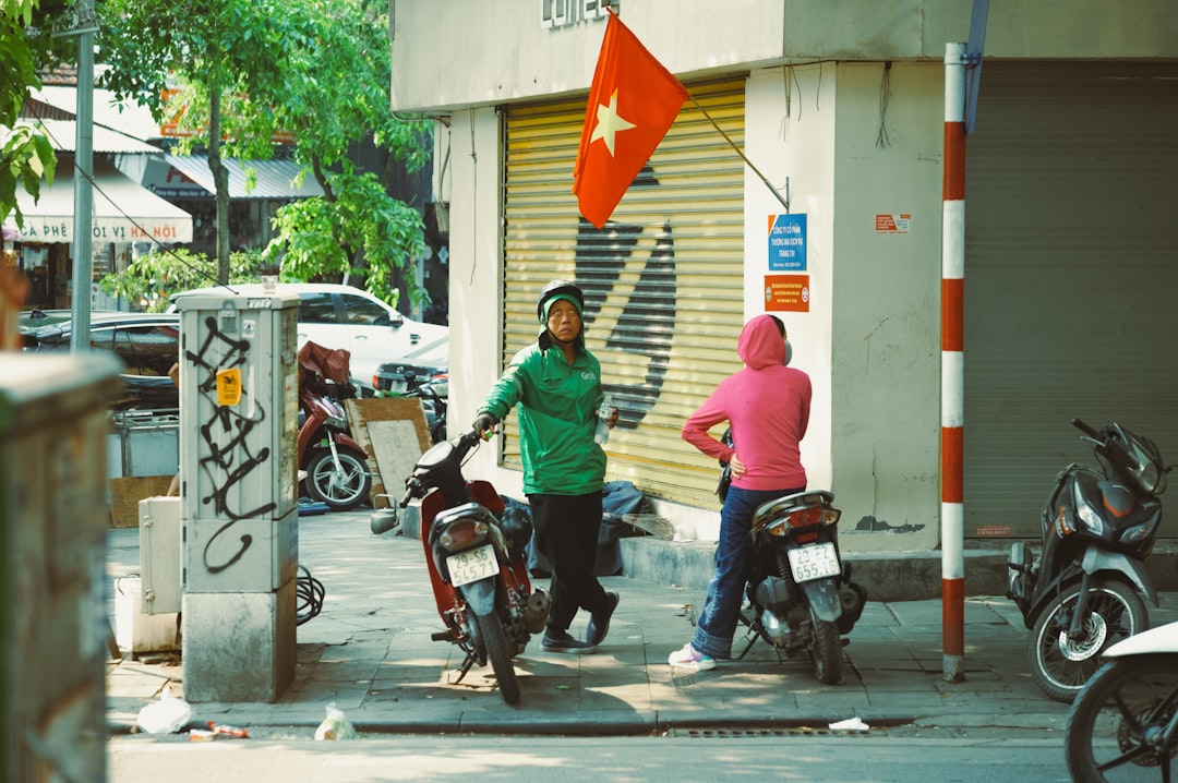 A man and a woman standing next to motorcycles
