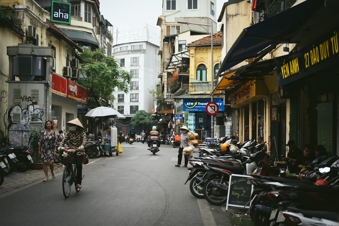 A group of people riding bikes down a street
