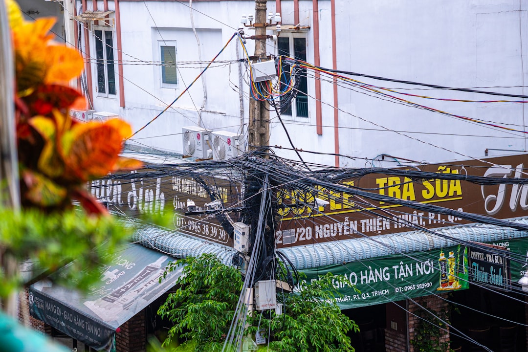 Tangled wires on a utility pole in a city