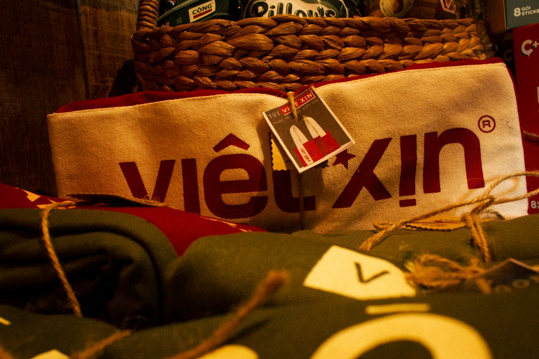 A white bag with "việt xịn" and folded green textiles.