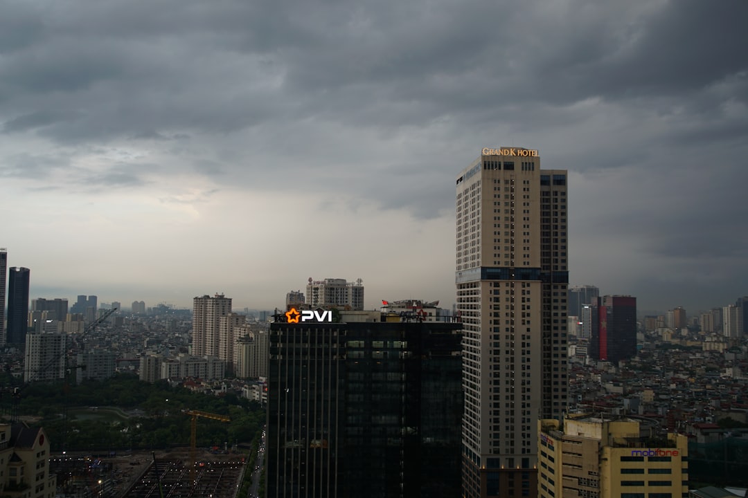 Cityscape with tall buildings under a dark, cloudy sky