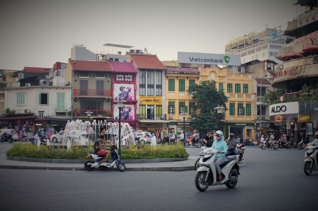 a group of people riding scooters down a street