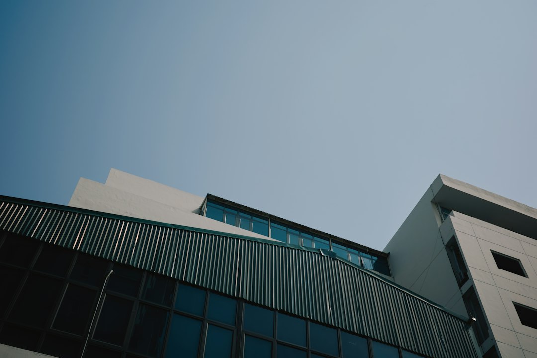 Modern building with glass windows against clear blue sky