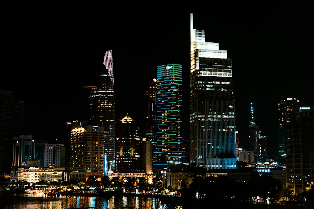 Illuminated skyscrapers along the riverfront in Ho Chi Minh City at night